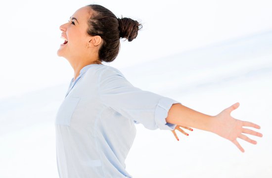 Laughing woman with arms outstretched